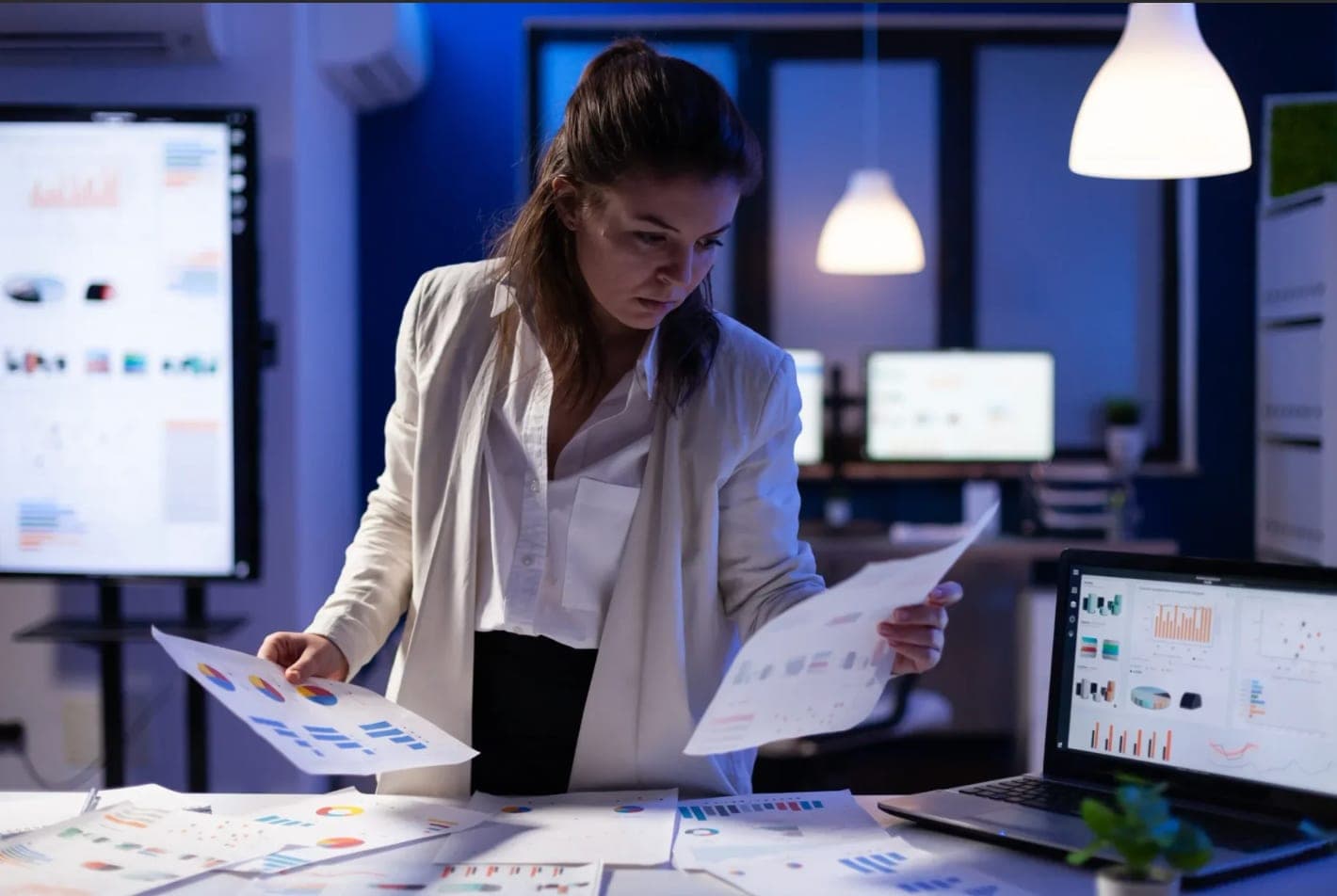 Financial analyst reviewing charts and reports at EA Accounting